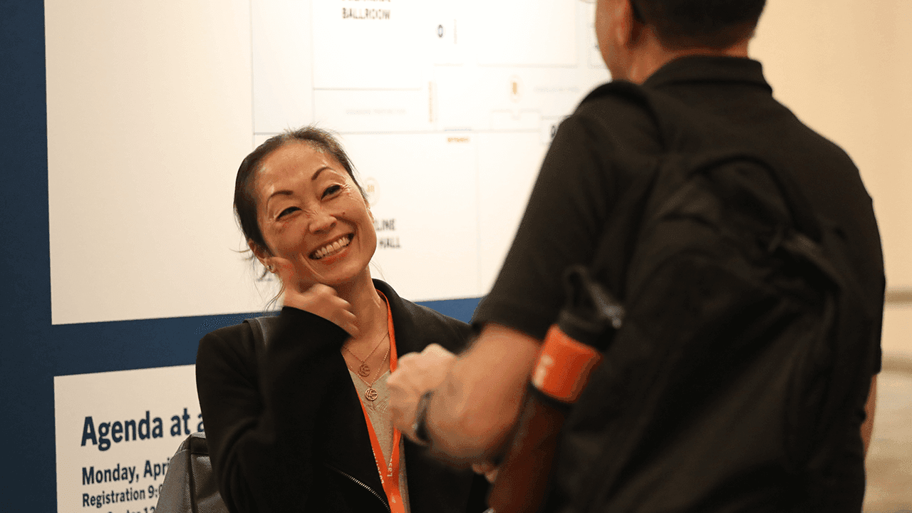Laserfiche employee smiling and giving an attendee the thumbs up